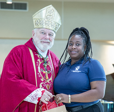 Archbishop Thomas Wenski poses with Nadine Destine of St. Elizabeth of Hungary Parish in Pompano Beach, one of two recipients of this year's Esperanza Ginoris Award for "exemplifying excellence in catechetical ministry." The awards were presented at the conclusion of the opening Mass of the annual Catechetical Conference, which brought more than 1,000 religious education volunteers and Catholic school teachers to St. Mark Church and Archbishop McCarthy High School in Southwest Ranches, Oct. 28, 2023.