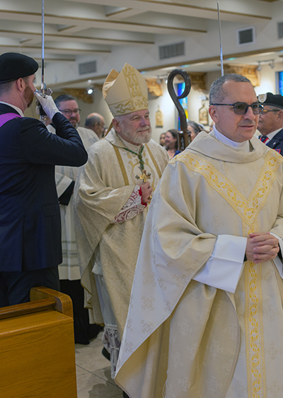 Archbishop Thomas Wenski and Father Matias Hualpa, Blessed Trinity's pastor, enter the church for the Mass marking the Virginia Gardens parish's 70th anniversary, Nov. 4, 2023.