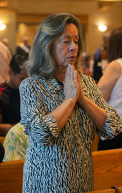 A parishioner prays during the Mass marking Blessed Trinity Parish's 70th anniversary, Nov. 4, 2023.