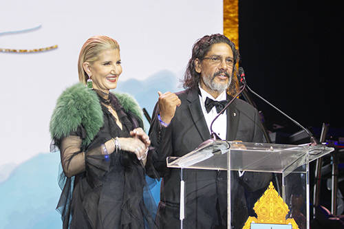 Attorney Jorge Luis Lopez, accompanied by his wife Marile, speaks at the 65th anniversary gala for the Archdiocese of Miami, Nov. 11, 2023, at the Miami Beach Convention Center. Their family foundation funds an annual scholarship for Msgr. Edward Pace High School students who need tuition assistance. Pace alumnus David Barbier, Jr., who shared his testimony at the gala, was one of the recipients in 2018.