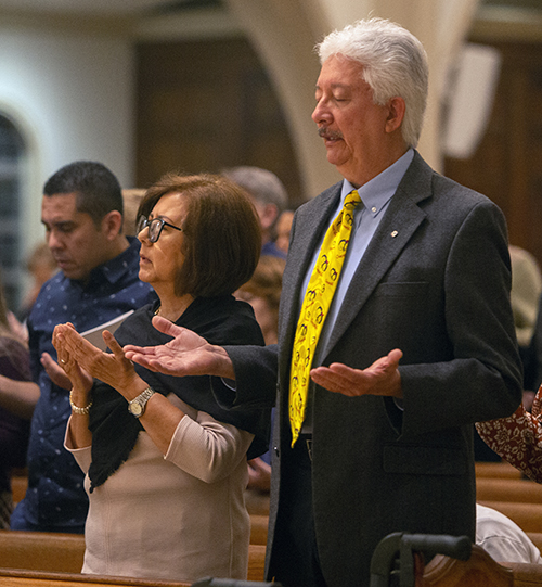 One in Faith awardee Ed Suazo recites the Lord's Prayer standing next to his sister, Ana Maria Isabel Suazo, at the annual ThanksforGiving Mass, which Archbishop Thomas Wenski celebrated Nov. 18, 2023.