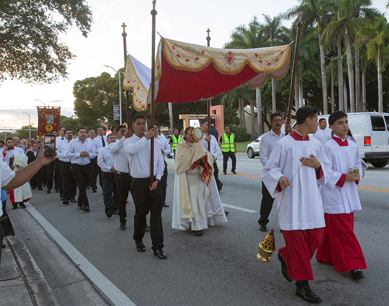 Father Elvis Gonzalez, St. Michael the Archangel's pastor, leads the procession with the Blessed Sacrament as hundreds accompany him along Flagler Street, from St. Michael Church to St. John Bosco Church,  Nov. 25, 2023. The procession coincided with the feast of Christ the King.