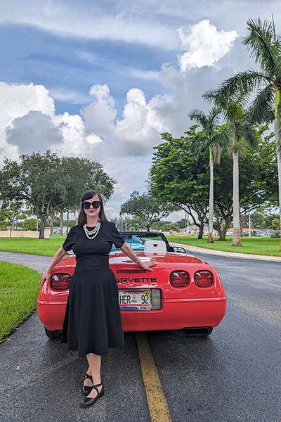 Breakfast at Tiffany's, anyone? Anna Ramos channels Audrey Hepburn in front of a bright red 1992 C4 owned by Diane Preuss. Photos of Ramos and this vehicle were taken by Gary Okoner, assisted by Michael Philippou with Jesse Stone consulting, and will be featured in the July 2025 pages of the Marian Center Corvette Calendar.