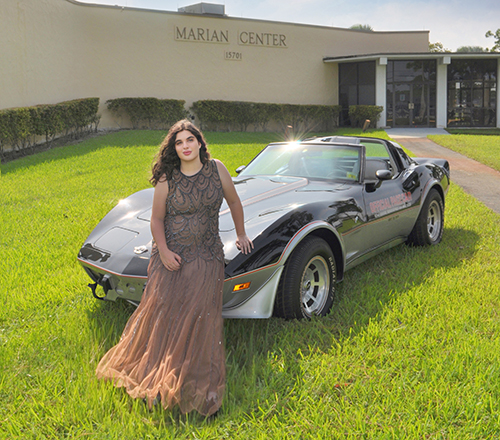 Laurel Miller is classy alongside a 1978 C3 Indy Pace Car in black and silver owned by Pat Carnevale. Photos of Miller and this vehicle were taken by Steve Williams, assisted by Jamie Bloom, for the January 2024 pages of the Marian Center Corvette Calendar.