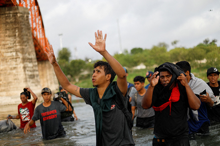 A Venezuelan migrant is seen from Piedras Negras, Mexico, Sept. 30, 2023, as he thanks God while walking through the Rio Grande in an attempt to cross into Texas to seek asylum in the United States. (OSV News photo/Daniel Becerril, Reuters)