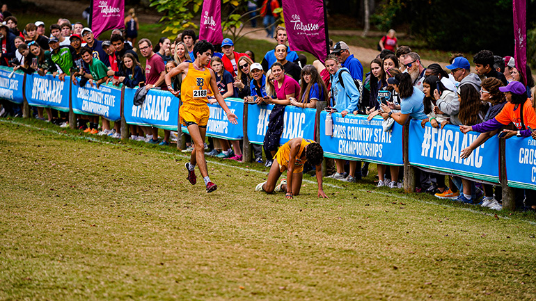 Belen senior Joseph Ruiz, left, encourages his brother, senior Joshua Ruiz, who collapsed near the finish line at the 2023 Florida High School Athletic Association Cross Country Championships, held Nov. 17, 2023, in Tallahassee. Belen still won its seventh consecutive state title.