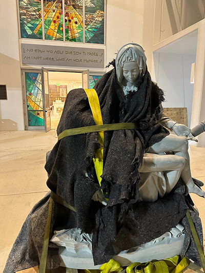 A bundled up replica of Michelangelo's La Pietà arrives at Our Lady of Guadalupe Church in Doral on the evening of Nov. 1, 2023, All Saints Day. The gift was generously donated by James L. Case, III, and Elise A. Case, in loving memory of their father, James L. Case. The replica was made by local sculptor, Nilda Comas, a friend of Case, who commissioned the work. Comas' other works at Our Lady of Guadalupe Church include the marble statue of the Guadalupe Virgin and the bronze cast of Christ on the crucifix at the altar.