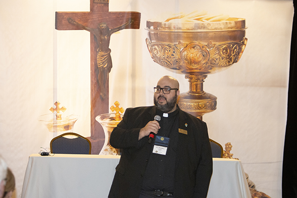 Father Matthew Gomez, director of vocations for the Archdiocese of Miami, speaks Jan. 19 at the 2024 Serra USA Rally, held Jan. 18-21 in Miami. He said "God is the one who calls. I just process the paperwork," but suggested every Catholic can plant the see of a vocation simply by asking young men and women they know, "Have you ever considered a vocation?" and allowing the "opportunistic" Holy Spirit to do the rest. The goal of Serra Club members is to foster vocations to the priesthood and religious life.
