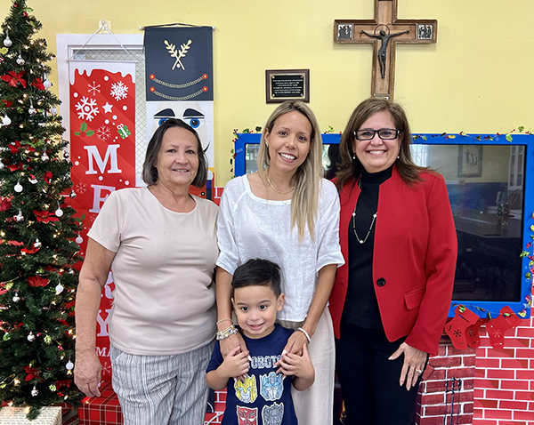 From left: Oliva Presiga, her grandson and current Good Shepherd Child Care student Gianlucca Mejia, his mother, Alejandra Presiga, and Alejandra’s former pre-K teacher, Otilia Penczak, are pictured at the center in Cutler Bay on Dec. 7, 2023.