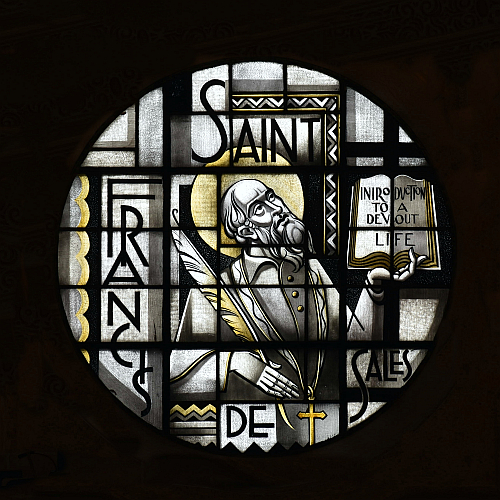 Rose window at St. Francis de Sales Church, Miami Beach, shows the saint with the title of his best-known work.