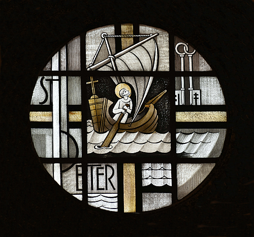 St. Peter is honored in this circular window at St. Francis de Sales Church, Miami Beach. He steers a boat for his pre-apostolic fishing trade. But he looks to the Keys of the Kingdom given him by Jesus.