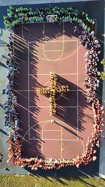 The entire student body of St. Timothy School came together on the  basketball court Jan. 30, 2024, to bring to life the colors of the Catholic Schools Week 2024 logo, "united in faith and community."