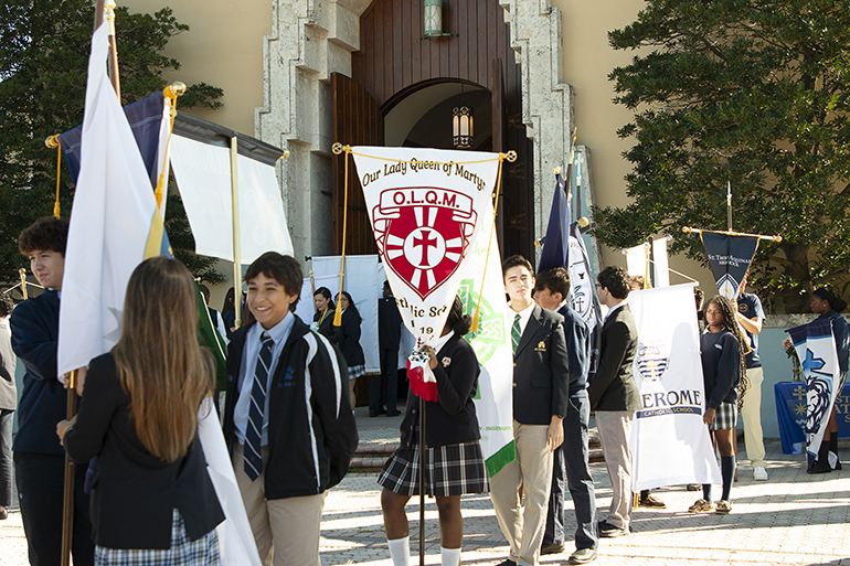 Carrying their school banners, representatives of all 64 archdiocesan elementary and high schools wait outside St. Mary Cathedral Jan. 31, 2024, for the start of the second annual All Schools Mass to mark Catholic Schools Week, Jan. 28-Feb. 3.