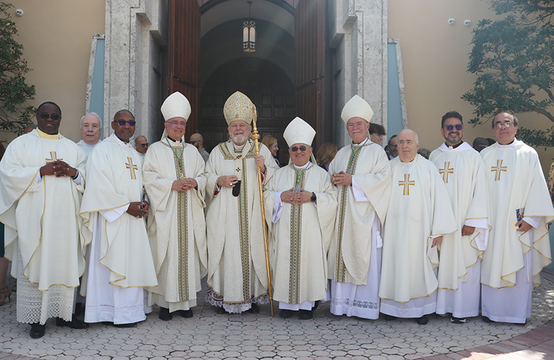 Archbishop Thomas Wenski, three bishops, and eight priests honored during the annual chrism Mass at St. Mary Cathedral, March 26, 2024, pose for a photo after the Mass; from left: Father Fidelis Uko, chaplain at Baptist Health's South Miami Hospital; Father Robert Bouffier, chaplain at Chaminade Madonna College Prep. in Hollywood; Father Robés Charles, pastor of Sacred Heart in Homestead; Bishop Silvio Baez, auxiliary of Managua, Nicaragua, currently living in exile in South Florida; Archbishop Thomas Wenski, who presided at the Mass; Miami Auxiliary Bishop Enrique Delgado; Bishop Fernando Isern, retired bishop of Pueblo, Colorado; Father Eduardo Alvarez, who recently retired as pastor of Gesu; Father Jaime Acevedo, pastor of St. Mark Church in Southwest Ranches; Father Juan de Dios Garcia Cortez, currently serving at Good Shepherd in Miami.