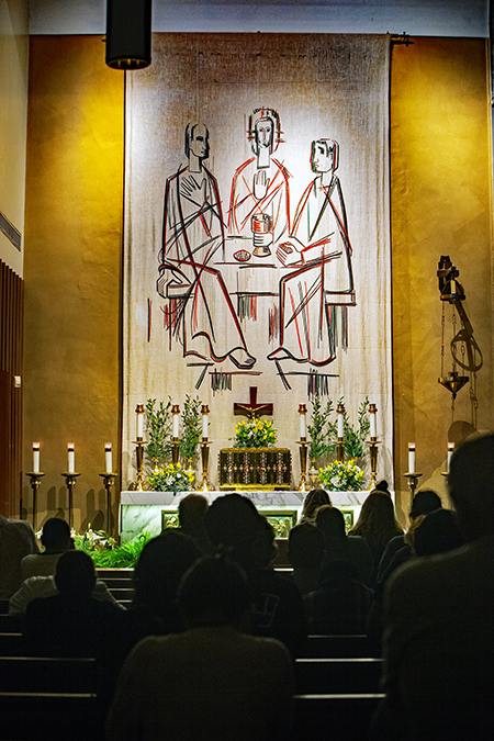 Churchgoers pray before the Blessed Sacrament with the Last Supper depiction displayed above the altar, at the conclusion of Holy Thursday Mass at St. Mary Cathedral, March 28, 2024.