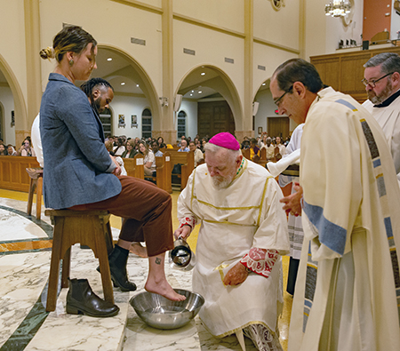Archbishop Thomas Wenski washes the feet of catechumen Niko Test during Holy Thursday Mass at St. Mary Cathedral, March 28, 2024.