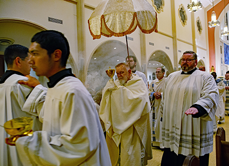 Archbishop Thomas Wenski carries the consecrated host in procession through St. Mary Cathedral at the conclusion of the Mass of the Lord's Supper on Holy Thursday, march 28, 2024.