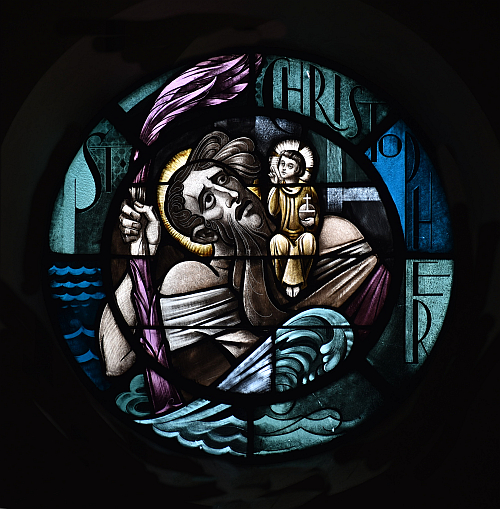 Christopher bears a young Jesus across a river in this window at St. Joseph Church, Miami Beach. The image is based on a legend.