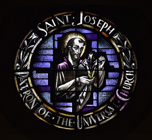 St. Joseph regards a lily in the rose window at his namesake church on Miami Beach. A lily is a traditional symbol of purity.