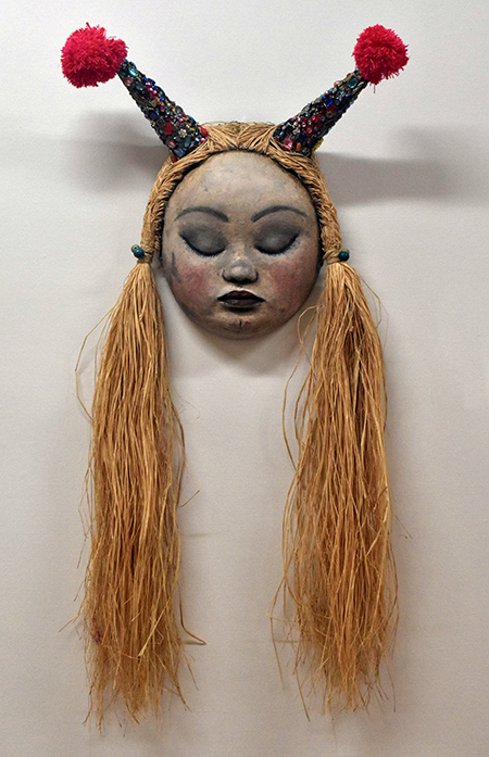 Mariana Monteagudo, from Venezuela, added her own artworks to the immigration conference March 21 at Barry University. Her doll-like faces blend global pop images with pre-Columbian culture.