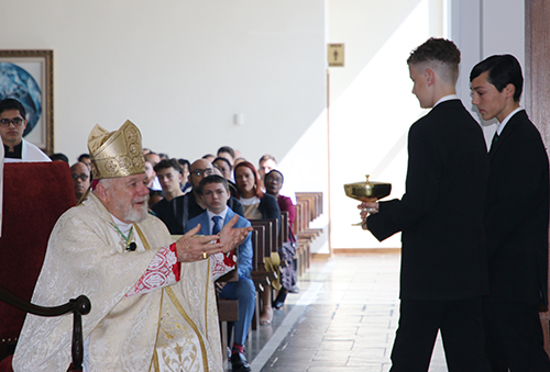Altar servers Rifino Litterdragt, of St. John XXIII Church, in Miramar, and Michael Triglia, Jr., of St. Kevin Church in Miami, bring the offertory gifts to Archbishop Thomas Wenski during Mass at the Altar Server Awards Ceremony on Saturday, April 20, 2024, at St. John Vianney College Seminary.