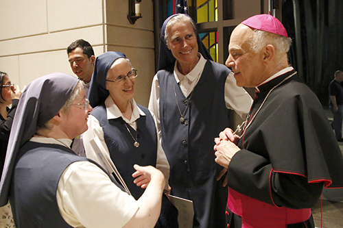 San Francisco Archbishop Salvatore Cordileone is greeted by the Daughters of St. Paul after celebrating the Requiem Mass for the Forgotten, March 15, 2024, at Epiphany Church in Miami.