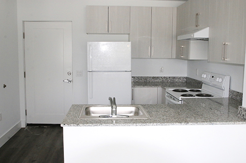 A look at one of the new apartments at Catholic Charities' Wenski Groves reveals countertops, a stove, a refrigerator, and more in the kitchen space of each unit. The Wenski Groves affordable housing complex was blessed by its namesake, Archbishop Thomas Wenski, April 26, 2024. The complex includes 30 apartments, 20 efficiencies, and 10 single-bedroom spaces.