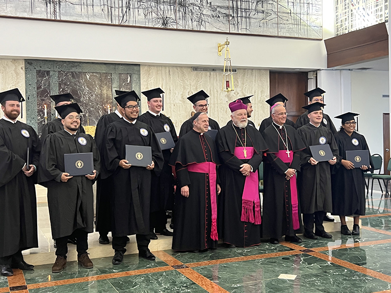 Twelve graduates pose with (front, middle) Msgr. Pablo Navarro, rector-president of St. John Vianney College Seminary; Archbishop Thomas Wenski; and Bishop Silvio Jose Baez, auxiliary of Managua, Nicaragua May 8, 2024 after the Commencement Ceremony and Baccalaureate Mass at St. John Vianney College Seminary.