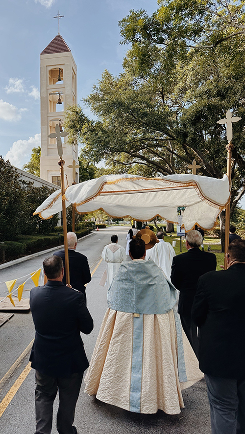 The faithful participate in a Eucharistic procession during the solemnity of Corpus Christi June 3, 2024, around the perimeter of St. Mark Parish in Southwest Ranches.