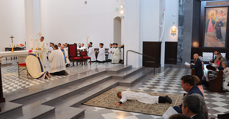 Archbishop Thomas Wenski and the congregation pray the Litany of the Saints as Deacon Michael Anthony Martínez, who is going to be ordained to the priesthood, lies prostrate in the sanctuary of Our Lady of Belen Chapel in Miami, June 1, 2024.
Archbishop Thomas Wenksi ordained Michael Anthony Martinez, S.J., to the priesthood on June 1, 2024, at the Our Lady of Belen Chapel.