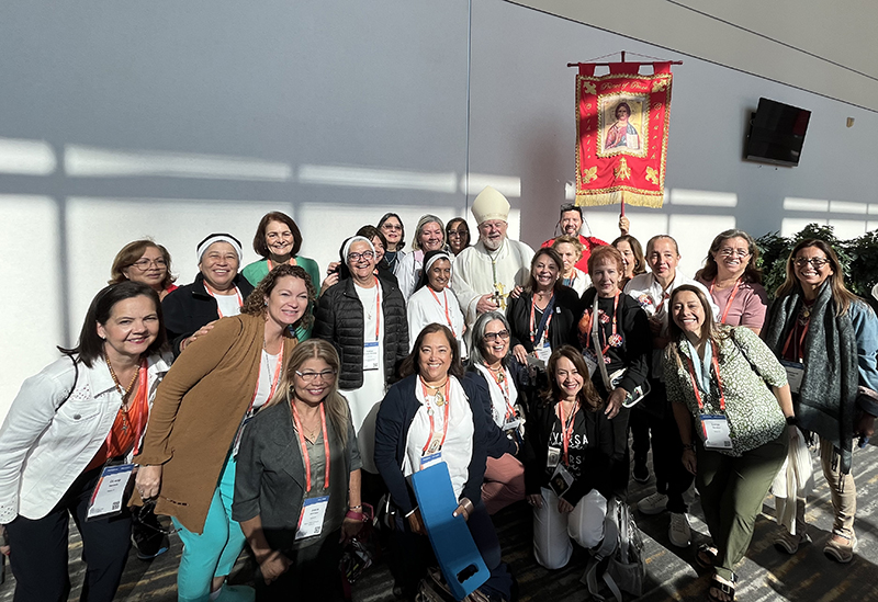 Some parishioners from Prince of Peace Parish in Miami who participated in the National Eucharistic Congress pose with Archbishop Thomas Wenski. The National Eucharistic Congress was held July 17-21, 2024, in Indianapolis, Indiana.