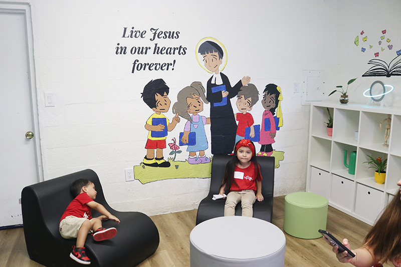 Jailyn Casas, 5, and her little brother explore some of the areas of their new school, the De La Salle Brothers' Little School in Homestead, on Aug. 18, after the school's blessing.