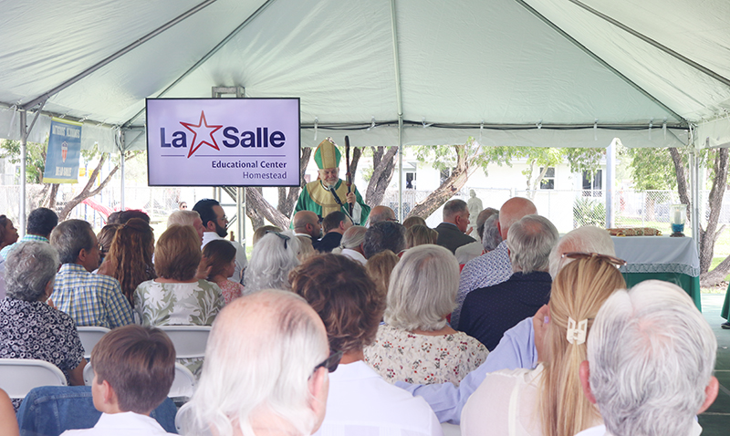 Archbishop Thomas Wenski, during his homily at the Mass marking the start of the school year in archdiocesan schools, blesses 'Little School,' a new school that will begin operating for grades pre-K through 4 on Aug. 18, 2024, at the La Salle Educational Center, located in the South Dade migrant worker camp in Homestead.