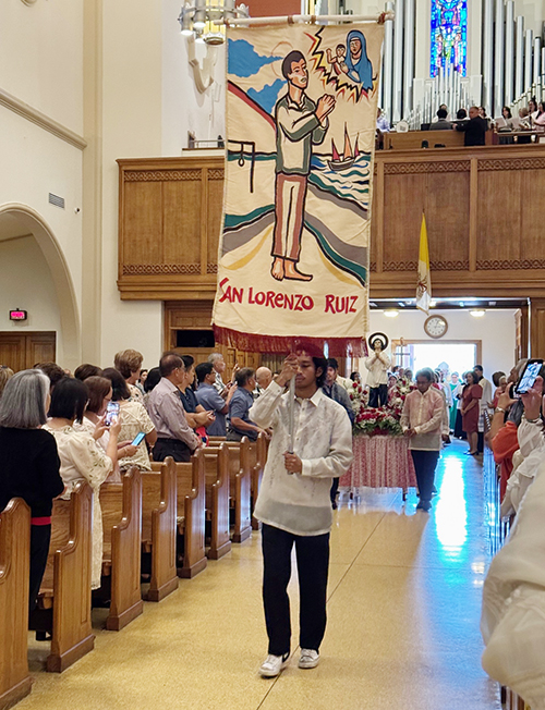 Banners from the Filipino Apostolate of Miami enter St. Mary Cathedral in Miami, at the beginning of the Mass in honor of San Lorenzo Ruiz, the first Filipino saint, celebrated by Archbishop Thomas Wenski, Sept. 29, 2024.