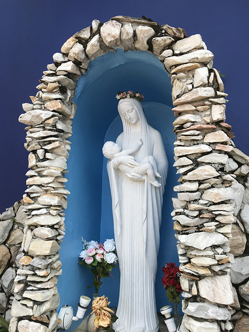 Mary cradles the Christ Child in this grotto in the prayer garden at Annunciation Church.