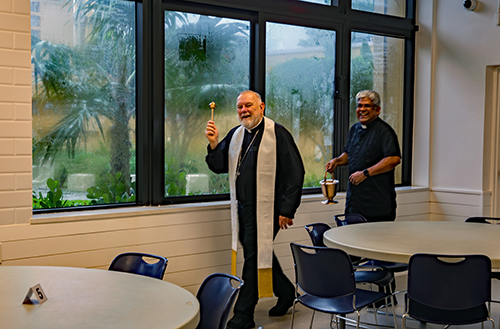 Archbishop Thomas Wenski blesses the newly renovated cafeteria at St. Rose of Lima School on Oct. 7, 2024. With him is Father George Packuvettithara, the pastor of the church. Renovations also included a new school courtyard and new hurricane-resistant windows.