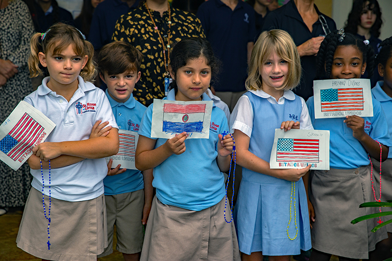 Second graders at St. Rose of Lima School, from left, Joy Stead, John Louis Segreti, Arami Freire Farina, Sloan Senecal and Hayana Dubos, hold paper flags of their native countries during the blessing of the school's renovated courtyard and cafeteria.
Archbishop Thomas Wenski blesses the newly renovated cafeteria of St. Rose of Lima School, Oct. 7, 2007. Renovations included a new school courtyard and new hurricane impact windows as well.