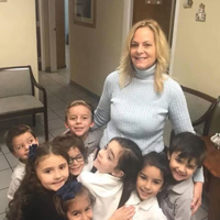 Principal Victoria Flutie-Leon poses with some of her youngest students at Immaculate Conception School in Hialeah.