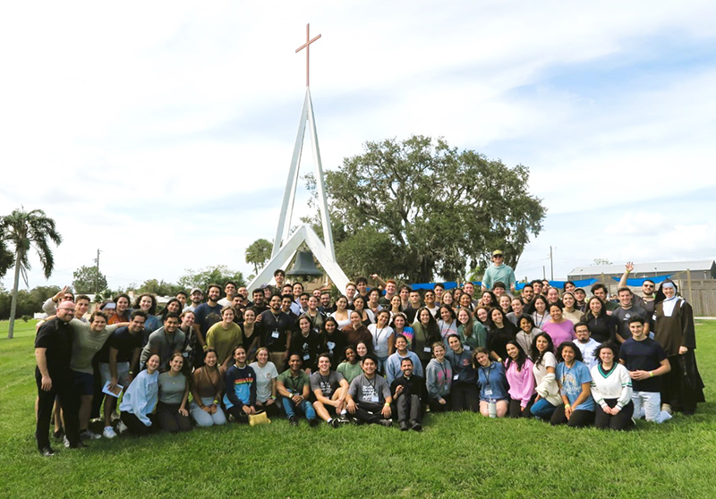 Attendees of the UM/FIU Fall 2024 Retreat smile for the camera during a group photo at Lake Placid, Florida. Attendees hailed from FIU, UCatholic campus ministry from the University of Miami, and students other South Florida colleges and universities.