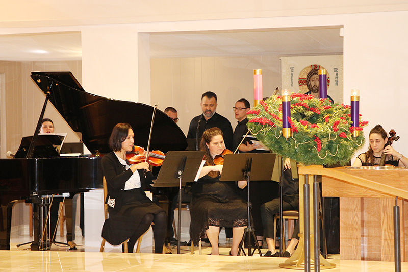 Violinists Alexia Franky, left, and Judy Sanchez perform at the Mass of rededication on Dec. 8 at St. Matthew Church. Franky said she feels inspired spiritually and musically in the restored worship space.
