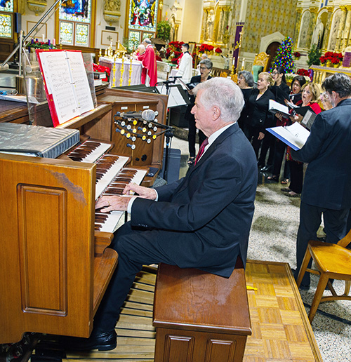 William VanderWyden III plays the organ as members of the St. John Neuman Music Ministry sing in the background. 
Archbishop Thomas Wenski celebrated annual Red Mass at Gesu Church of Miami on Dec. 11, 2024.