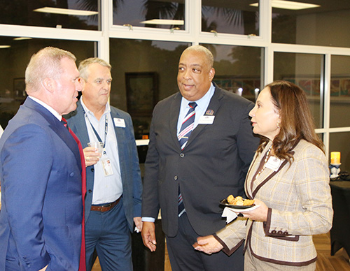 From left: St. Thomas University President David Armstrong, dean Colin Roche of Biscayne College, dean David Edwards of the Gus Machado College of Business and provost Michelle Johnson-Garcia speak at the reception held Jan. 10, 2025 for 11 incoming students and 14 preparing to graduate from a master's degree program in Catholic educational leadership at St. Thomas University.