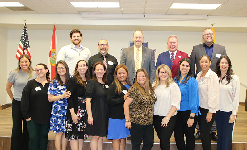 Pictured are the first cohort of 14 teachers from archdiocesan Catholic schools preparing to complete a master's degree program in Catholic educational leadership at St. Thomas University in Miami Gardens at a celebration reception on Jan. 10, 2025. In the back row are superintendent of the Office of Catholic Schools Jim Rigg, center, and President David Armstrong, second from right. The degree program was designed by STU and the archdiocesan Office of Catholic Schools to prepare future principals.
