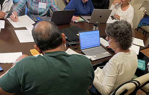 A volunteer with the Immigrant Assistance Project at Corpus Christi Parish helps an immigrant fill out immigration forms, Jan. 15, 2025, at Corpus Christi Parish following the immigration information session presented by Catholic Legal Services of the Archdiocese of Miami.