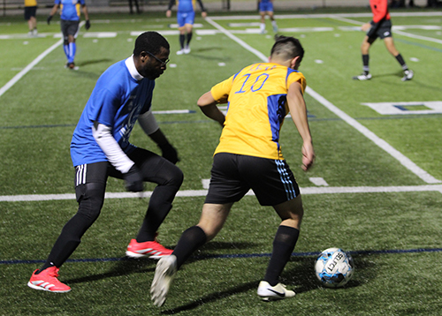 Seminarian Darvin Leiva (10) chases after the ball with Father Cletus Omode looking to steal during the third annual Archbishop's Cup soccer game, played Jan. 24, 2025, on the field of St. Thomas University, Miami Gardens. The seminarians beat the priests 4-0.