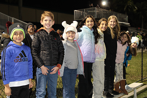 A crowd of young fans watch and cheer from the sidelines at the third annual Archbishop's Cup soccer game between priests and seminarians, played Jan. 24, 2025, on the field of St. Thomas University, Miami Gardens. The seminarians defeated the priests 4-0.