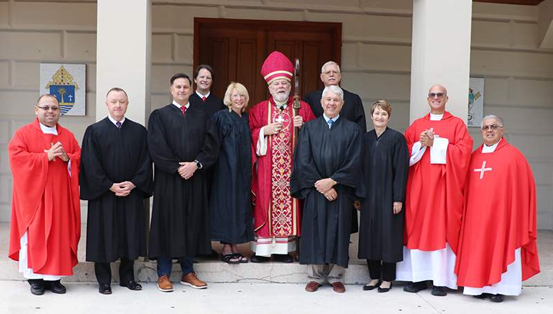 Archbishop Thomas Wenski, who celebrated the annual Red Mass for Monroe County March 14, 2025 at the Basilica of St. Mary Star of the Sea, poses for a group photo with regional judges and some of the archdiocesan priest who concelebrate the Mass.