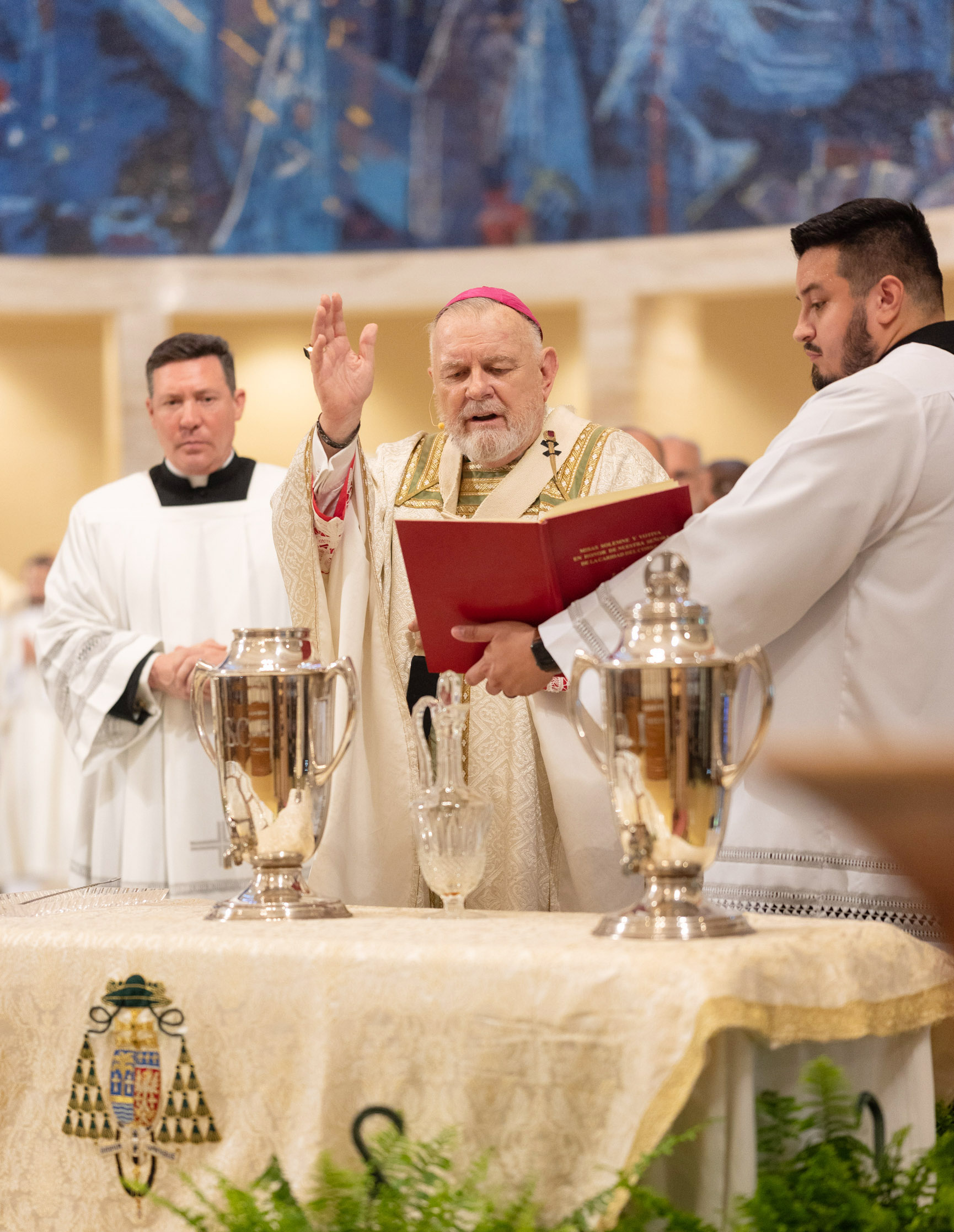 Archbishop Thomas Wenski blesses the oil of chrism, far left, at the conclusion of the chrism Mass April 15, 2025.