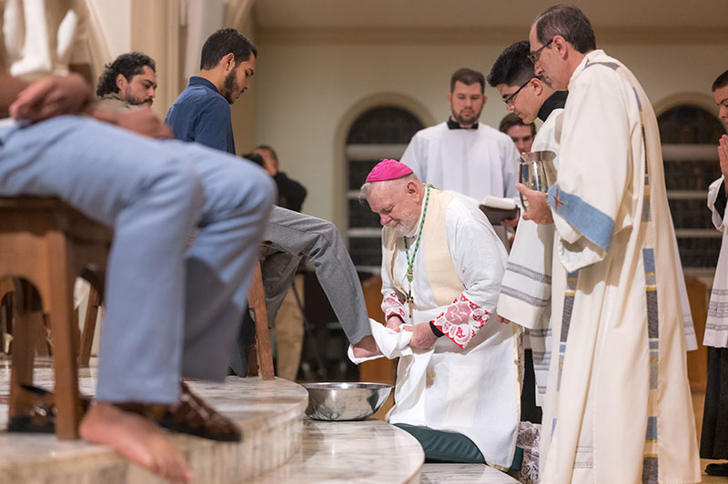 Archbishop Thomas Wenski dries the feet of Andres Reyes during Holy Thursday Mass of the Last Supper at St. Mary Cathedral in Miami, April 17, 2025. The archbishop washed the feet of six candidates and catechumens who will receive the sacraments of initiation at the Easter Vigil.