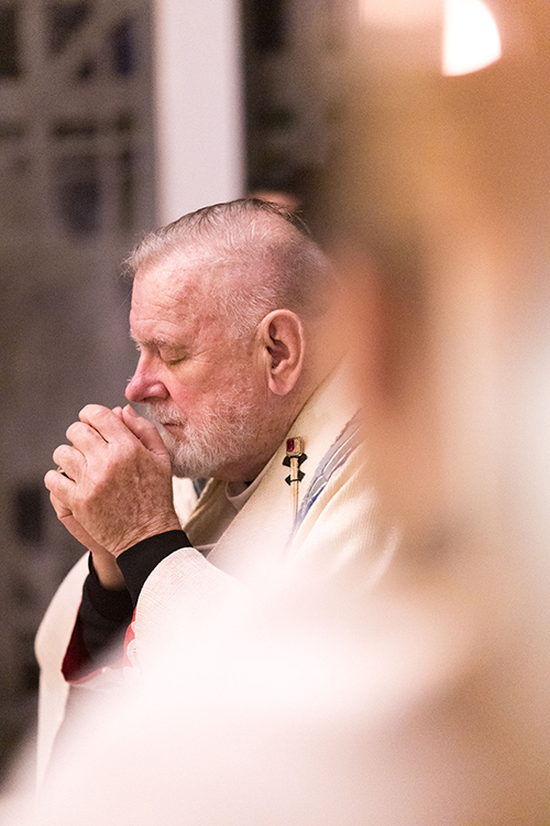 Archbishop Thomas Wenski prays before the Blessed Sacrament at the conclusion of Holy Thursday's Mass of the Last Supper at St. Mary Cathedral, April 17, 2025. The archbishop washed the feet of six candidates and catechumens who will receive the sacraments of initiation at the Easter Vigil.